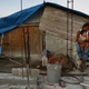Mother Isamar holds her baby Saniel, 9 months, at their makeshift home, under reconstruction, after being mostly destroyed by Hurricane Maria, on December 23, 2017 in San Isidro, Puerto Rico.